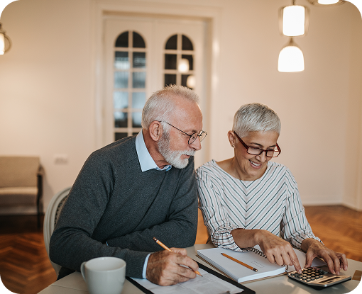 An older couple reviewing paperwork at a table