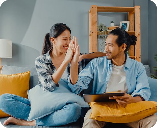 A couple celebrating together on a sofa