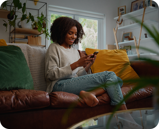 A person using a phone while relaxing on a sofa