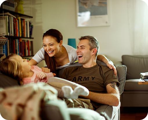 A family playing together on a sofa at home