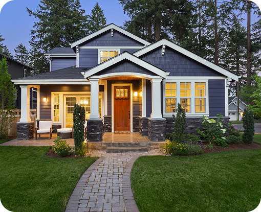 A suburban house lit up at dusk