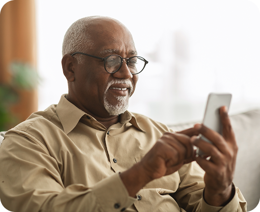 An older man looking at his phone