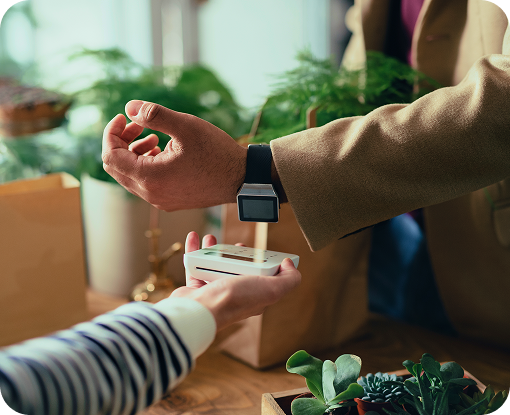 Close-up of a hand passing a small package to a customer
