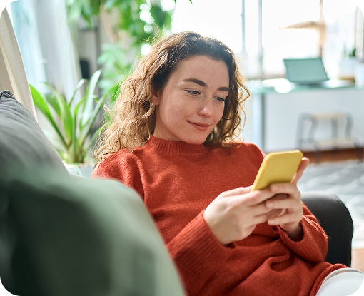 A person using a phone while relaxing on a sofa