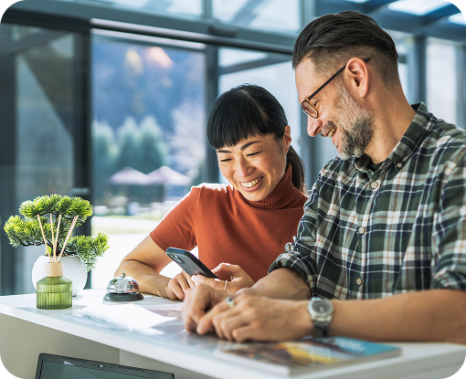 Two people reviewing documents at a kitchen table