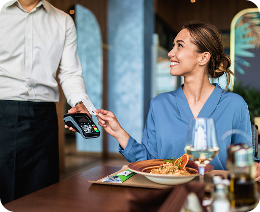 A diner paying by card at a restaurant table