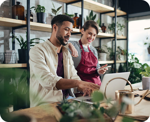 Two business owners reviewing paperwork together in a shop