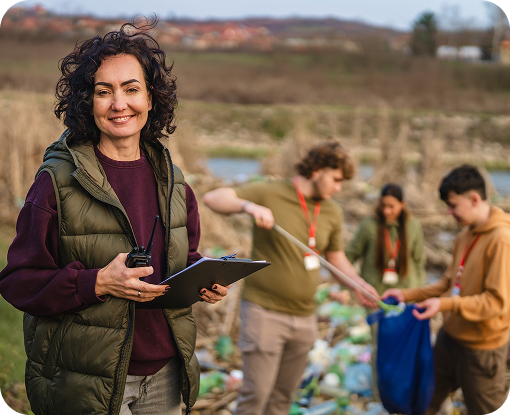 A volunteer holding a clipboard during an outdoor litter pick