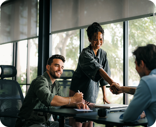 People working at tables in a bright open office