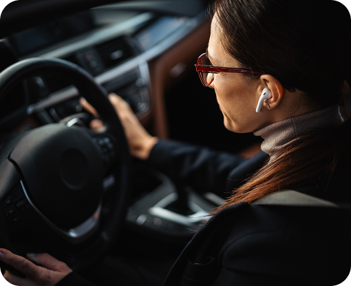 A driver with hands on the steering wheel