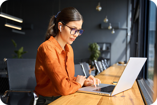 A person working at a laptop at home