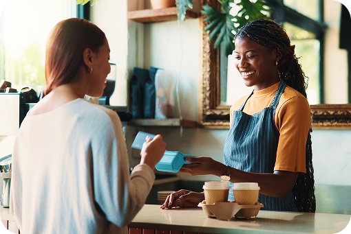 A customer and a barista talking at a coffee shop counter