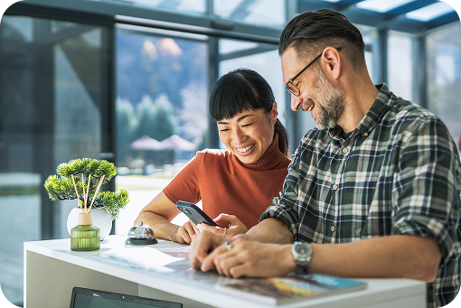 Two people reviewing documents at a kitchen table