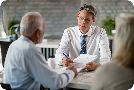 Two people reviewing documents across a desk