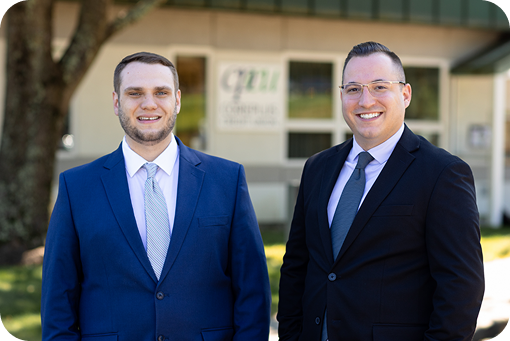 Two advisors in suits standing outdoors