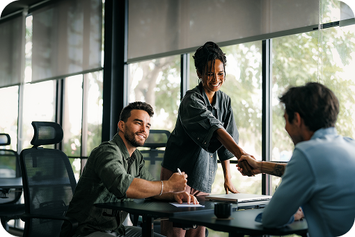 People working at tables in a bright open office