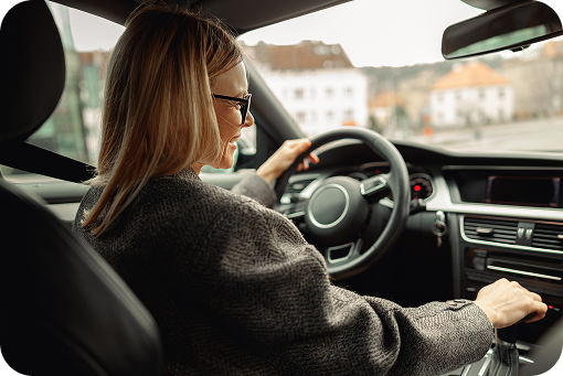 A driver adjusting controls in a car