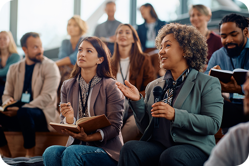An audience taking notes during a seminar