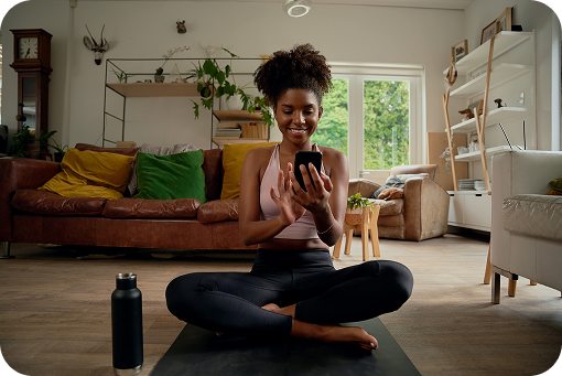A person sitting on the floor using a phone at home