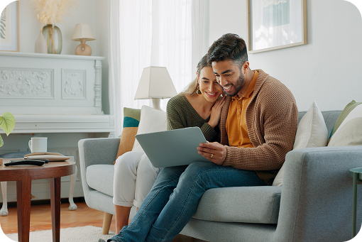 A couple sitting together on a sofa at home