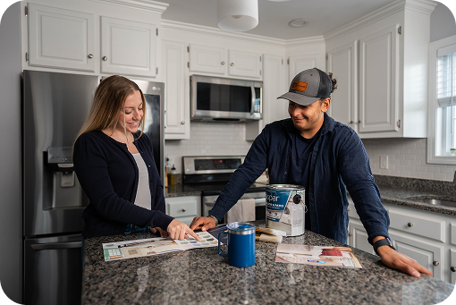Two people talking across a kitchen counter during a renovation