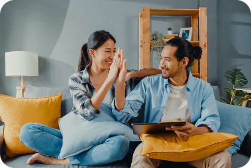 A couple celebrating together on a sofa