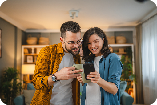 A couple looking at a phone together in their kitchen