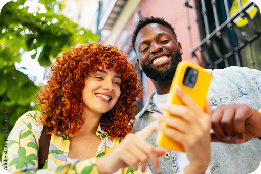 Two friends taking a selfie on a phone outdoors