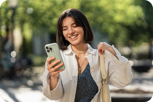 A person looking at their phone outdoors