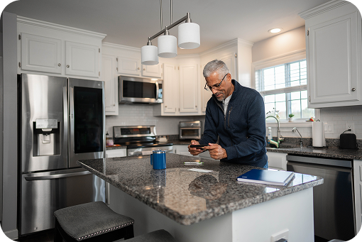 A person working at a kitchen counter with a laptop