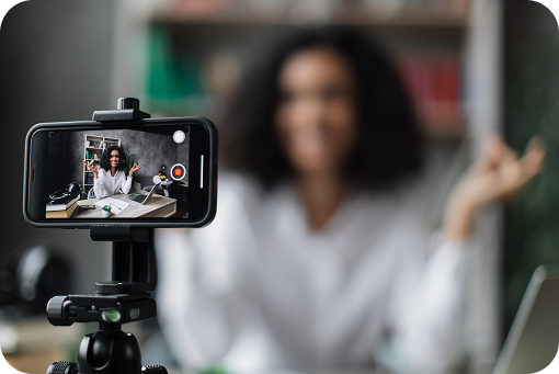 A smartphone on a tripod recording a person speaking to camera