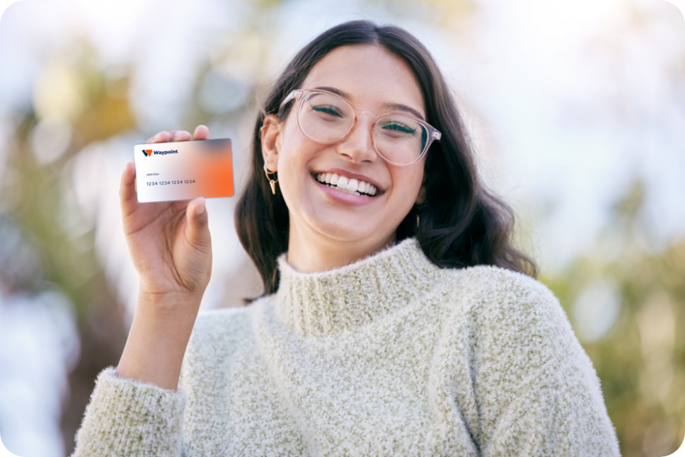 A hand holding a Waypoint Credit Union debit card
